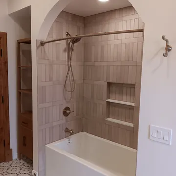 Custom bathtub surround with detailed trim from a Leelanau County bathroom remodel