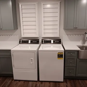 Custom laundry room remodel with functional storage by P.C. Building Company in Leelanau County, Michigan